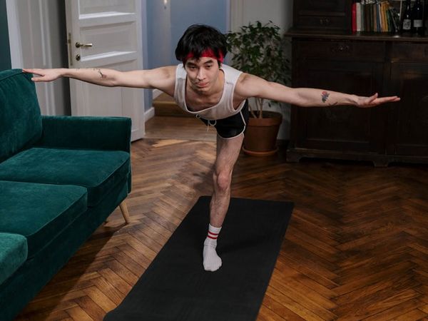 Person holding a challenging yoga pose demonstrating focus and strength.